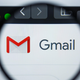 A magnifying glass over the Gmail logo on a computer is shown.